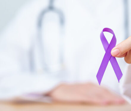 Doctor holding purple Ribbon for Violence, Pancreatic, Esophageal, Testicular cancer, Alzheimer, epilepsy, lupus, Sarcoidosis and Fibromyalgia. Awareness month and World cancer day concept